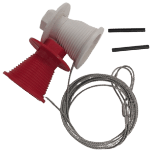 Spooling device with red and white plastic reels and braided steel cable, plus two black pins nearby