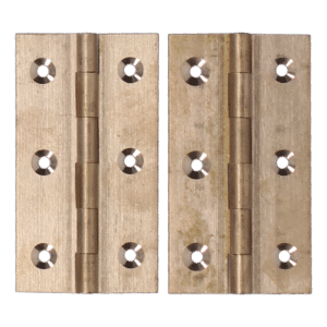 Pair of brass door hinges laid side by side, showing pins in the center and four screw holes on each leaf.