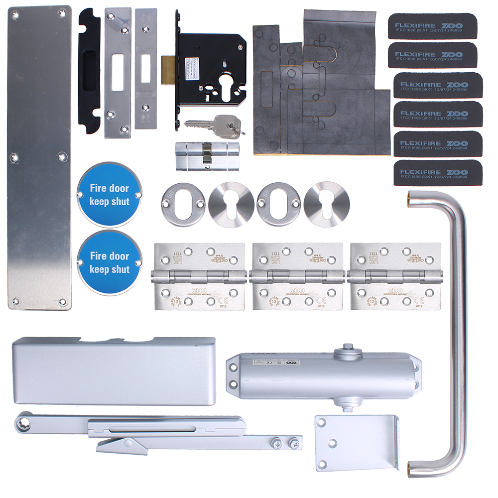 L38368_1 - Ironmongery Warehouse Full fire door hardware kit including hinges, locks, strike plates, a door closer, handle bar, and blue 'Fire door keep shut' signs laid out in a grid view of metal components.