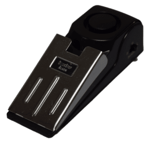 Door stop alarm device with a metal front plate and black housing.