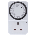 Plug-in mechanical timer with circular dial mounted above a white outlet plate.