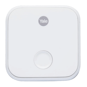 White Yale smart home device: a white square unit with a centered circular button at the bottom edge, brand logo at top center.