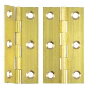 Pair of brass door hinges laid side by side, showing knuckles and multiple screw holes for mounting