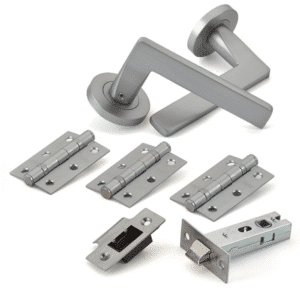 Brushed metal door handle with hinges, strike plate, and mortise lock kit for a door installation.