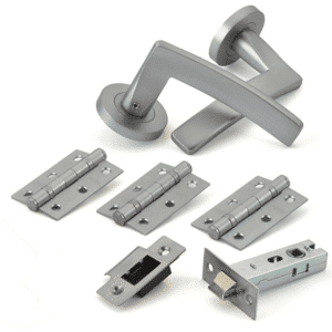 Door hardware kit including a lever handle, three hinges, a latch strike plate, and a mortise lock body for a door.